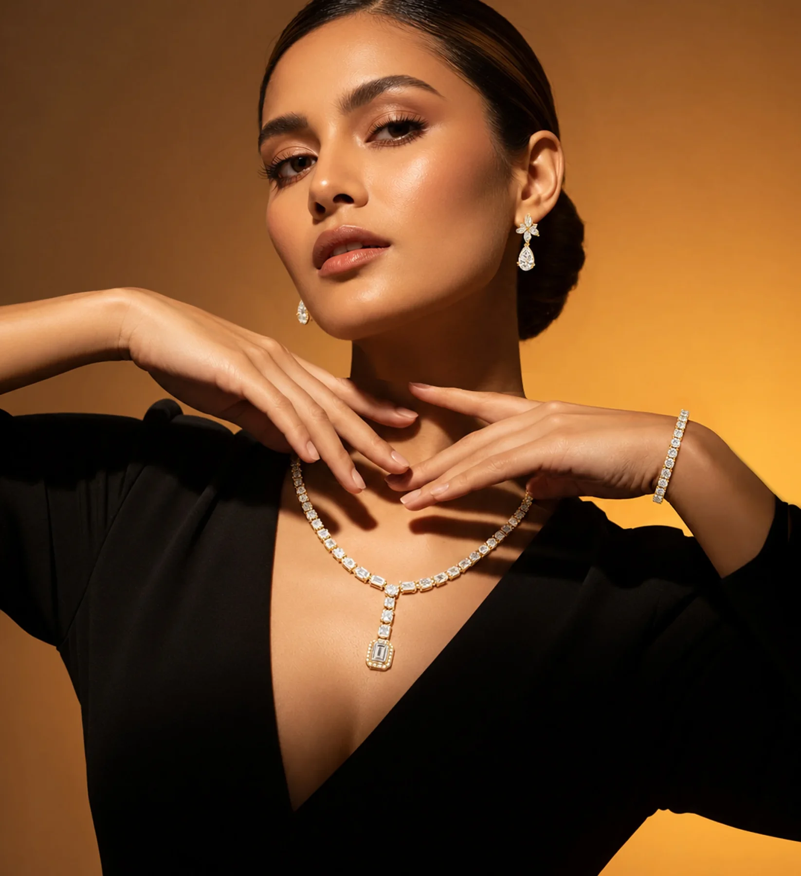 A woman wearing an Akoirah diamond necklace, drop earrings and a tennis bracelet
