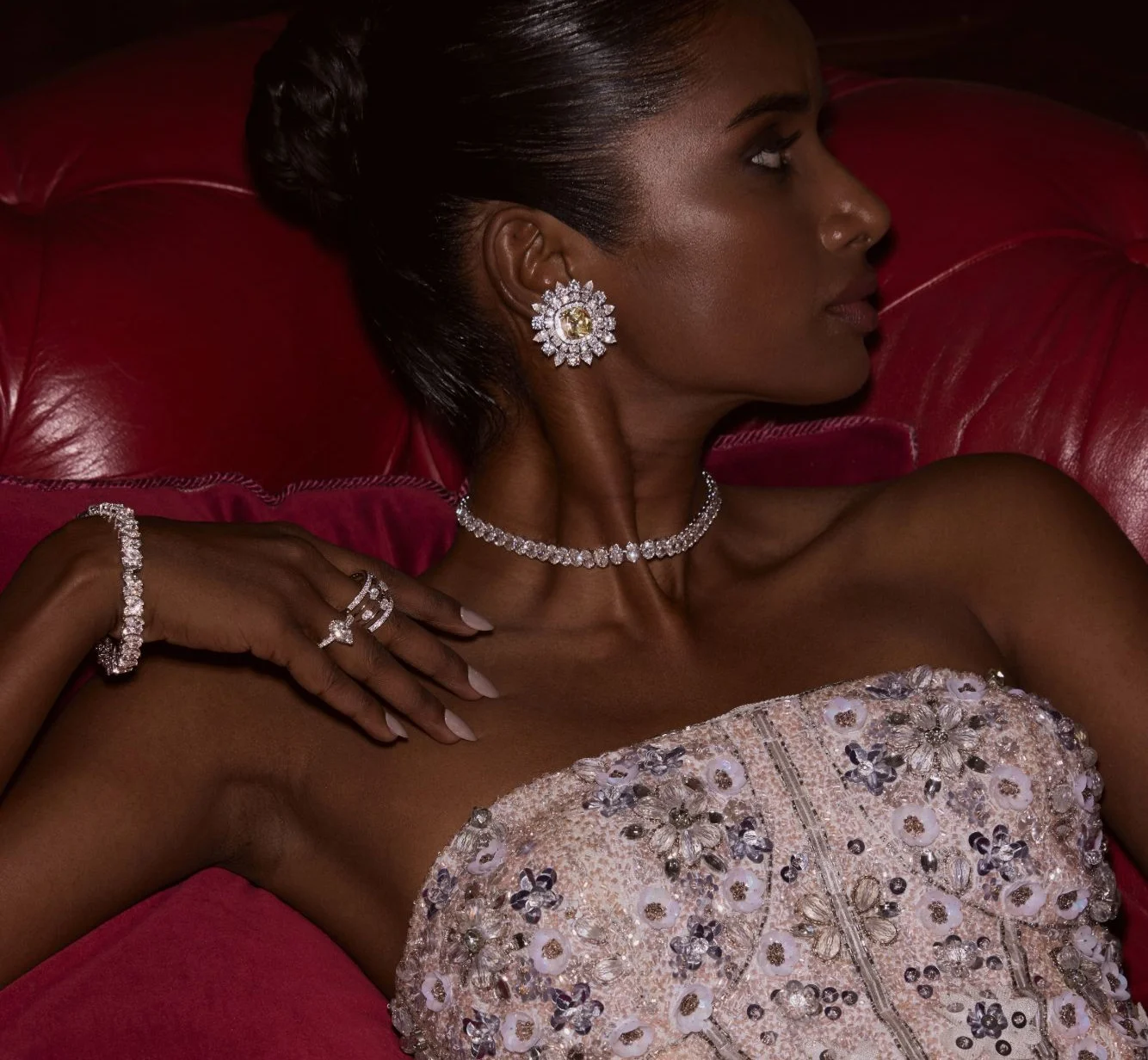 A model wearing Akoirah diamond earrings, a choker, rings and bracelets