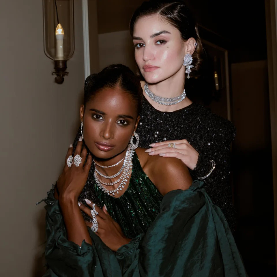 Two models wearing Akoirah lab-grown diamond necklaces, earrings and rings